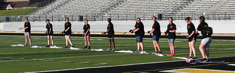 Girls from the Gatesville marching band lined up on the football field